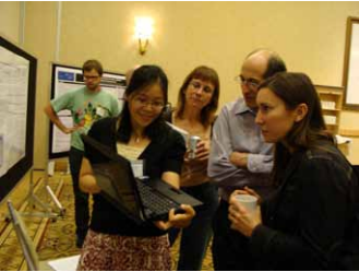 Victoria Wong, University of California, Davis Medical Center (holding laptop), presents her research to Congress attendees during the poster sessions.