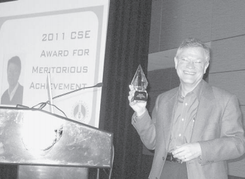 John Sack is all smiles as he shows off his award after ceremonies at CSE’s annual meeting in Baltimore, MD, this May. Photo by David Stumph.